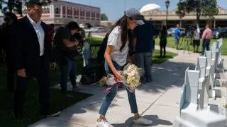 Duchess of Sussex, leaves flowers at a memorial site, Thursday, May 26, 2022, for the victims killed in this week’s elementary school shooting in Uvalde.